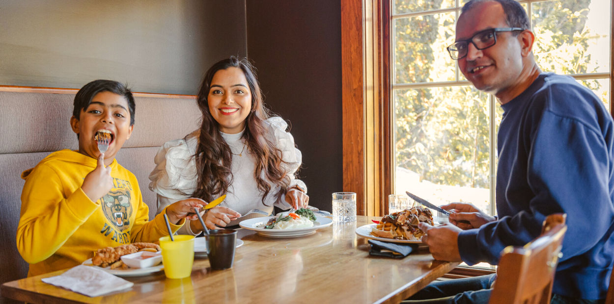 Family of three eating at a restaurant